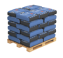 Pallet stacked with blue and black bags of adhesive used in external wall insulation systems. These adhesives are essential for securely bonding insulation boards to various surfaces, ensuring long-lasting thermal protection and structural stability.