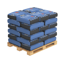 Pallet stacked with blue and black bags of adhesive used in external wall insulation systems. These adhesives are essential for securely bonding insulation boards to various surfaces, ensuring long-lasting thermal protection and structural stability.